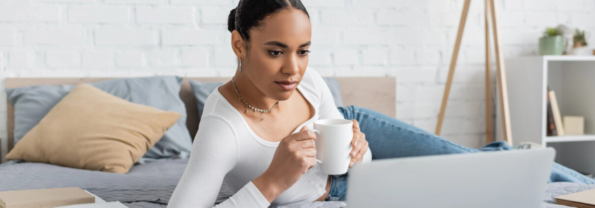 A woman relaxes into a hypnotherapy session on her computer